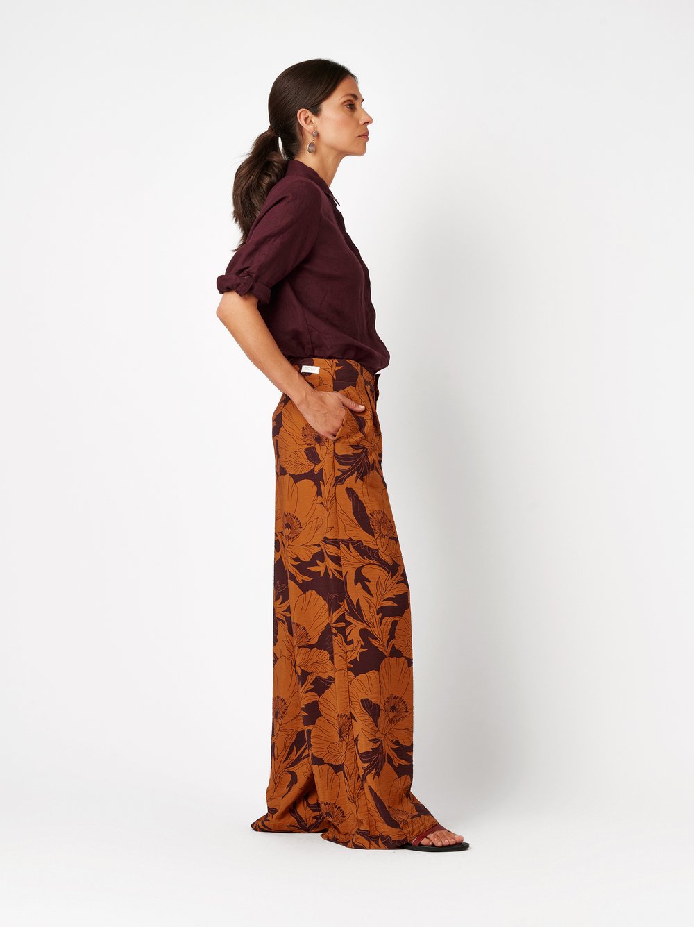 Womens trousers Elli Wide in orange, wide-leg pants with floral print and crepe texture, front view worn by model