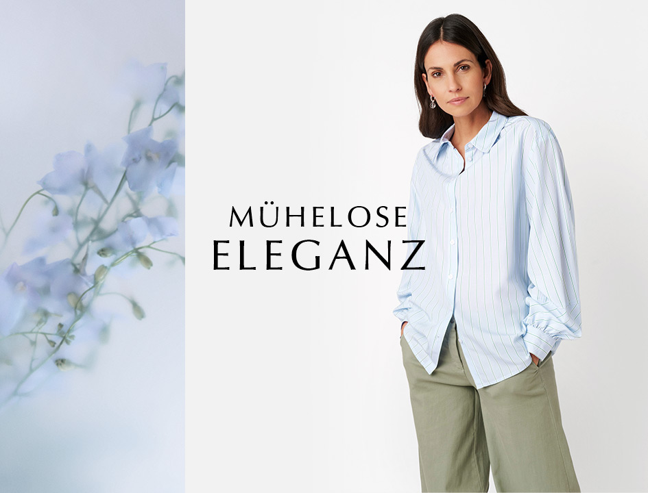 Modell in hellblauer Bluse und weiter Hose vor floraler Kulisse – Teaser zur Rubrik „Mühelose Eleganz“ von TONI