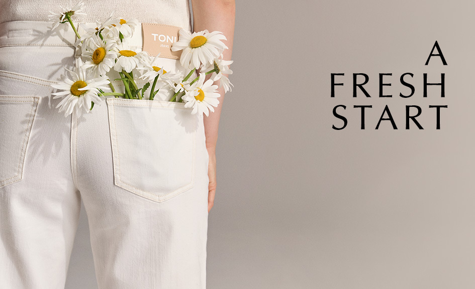 Model wearing white TONI jeans with daisies in the back pocket – teaser for the New Arrivals category and seasonal refresh