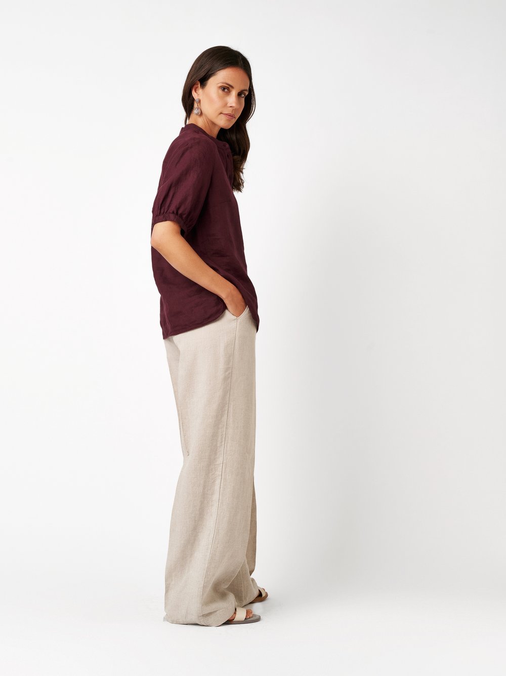 Womens blouse Alis in berry, linen blouse with a band collar, back view worn by model
