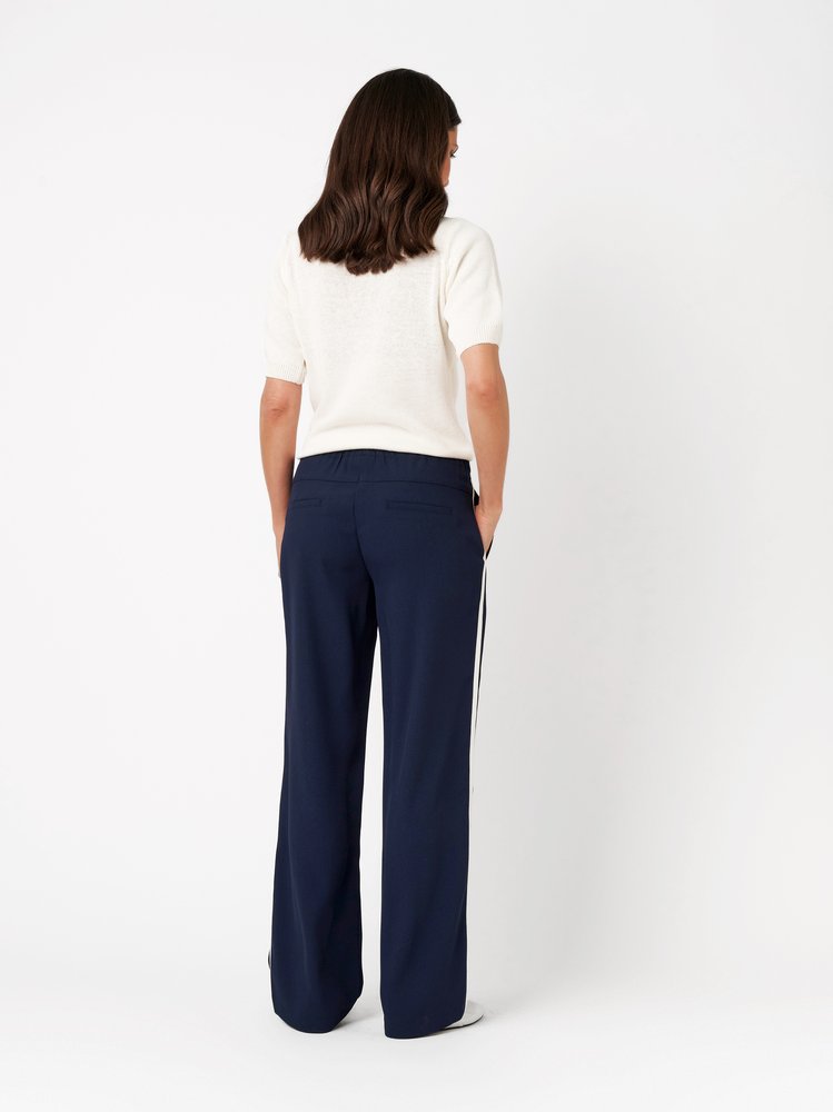 Womens trousers Sue Wide in dark blue, wide-leg jogpants with side stripes, back view worn by model