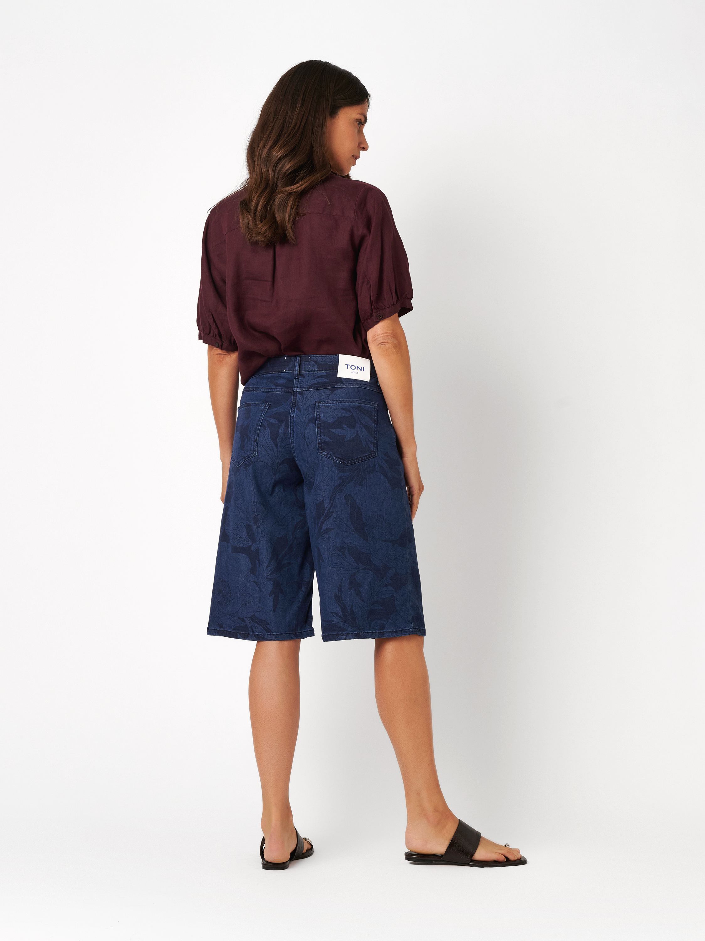 Womens shorts Liv Bermuda in dark blue, wide denim bermudas with floral print, back view worn by model